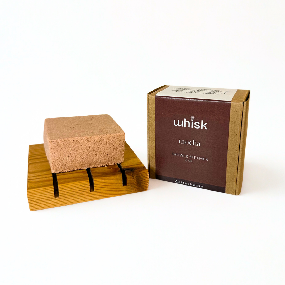 Mocha-colored shower steamer with packaging on a white background